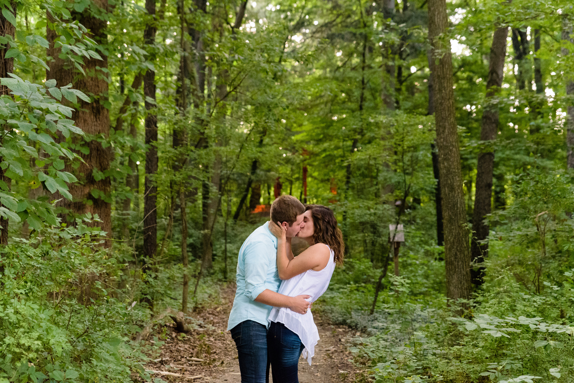 Engaged couple in the woods on the campus of the University of Notre Dame