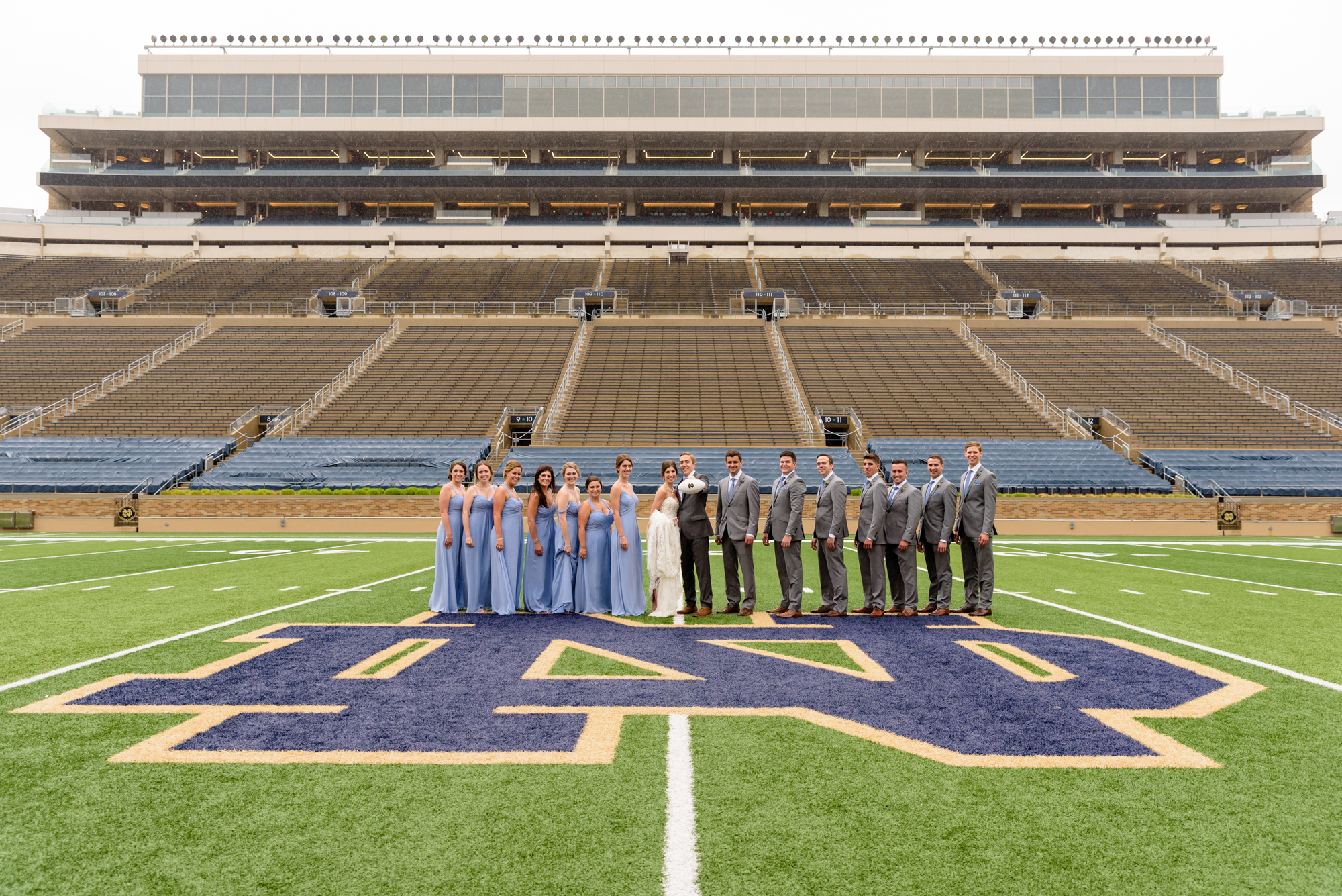 Bridal Party on Notre Dame football field after their wedding ceremony at the Basilica of the Sacred Heart on the campus of the University of Notre Dame