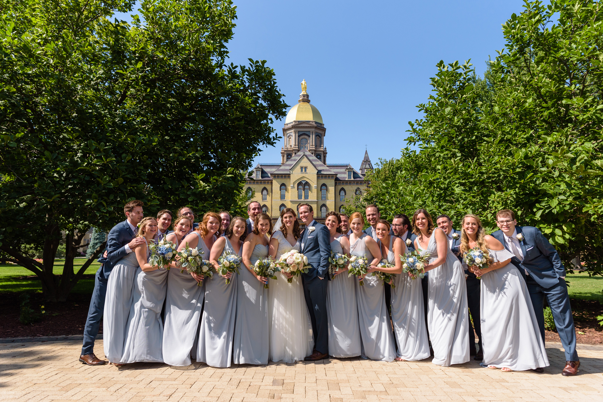 Bridal Party in front of the Golden Dome after a wedding ceremony at the Basilica of the Sacred Heart on the campus of the University of Notre Dame