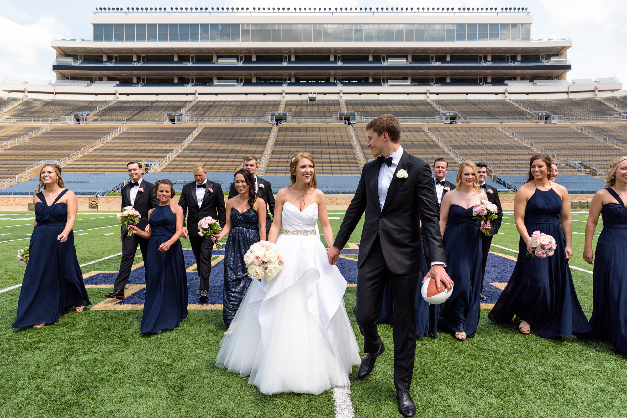 Bridal Party on Notre Dame football field after their wedding ceremony at the Basilica of the Sacred Heart on the campus of the University of Notre Dame