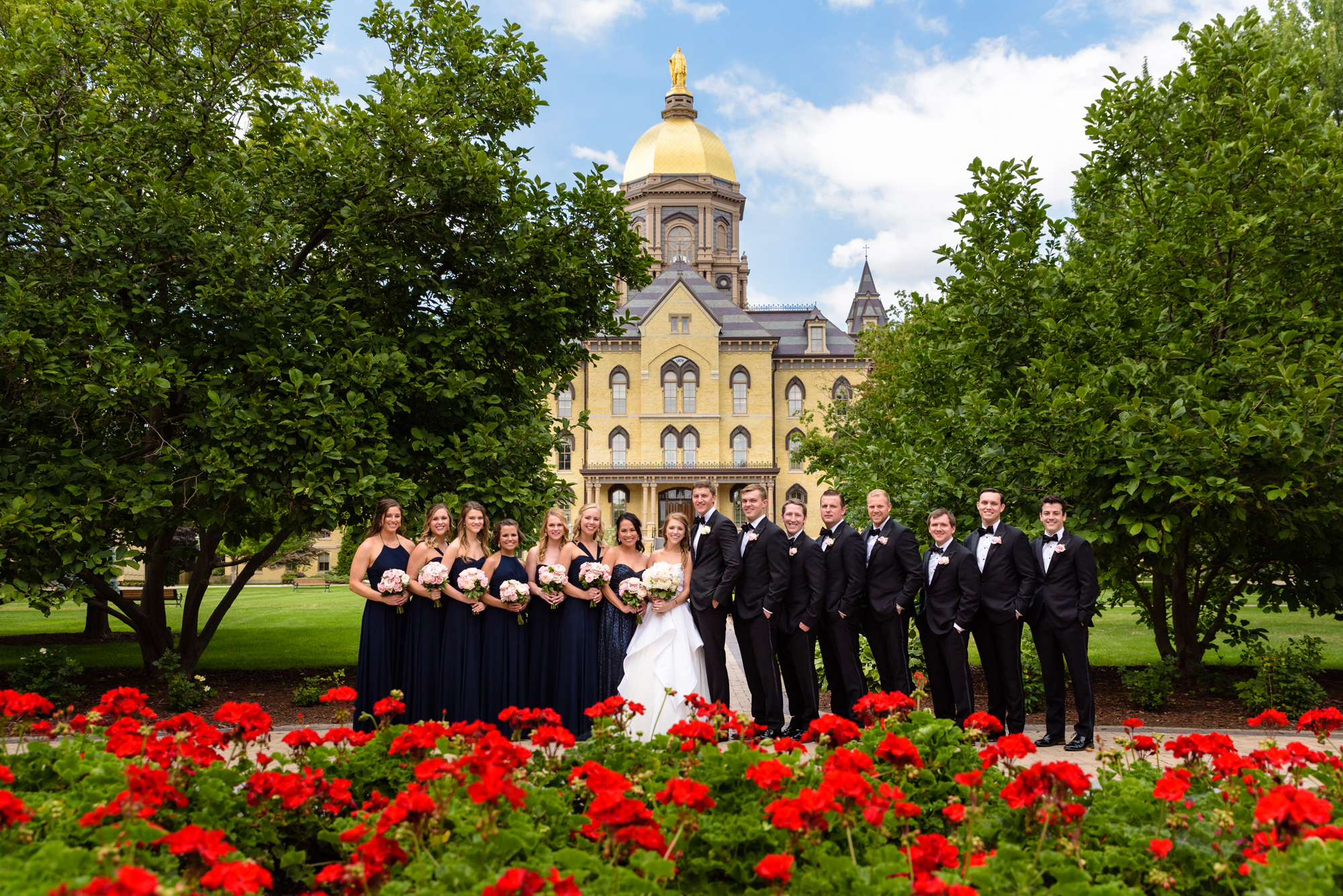 Bridal Party in front of the Golden Dome after a wedding ceremony at the Basilica of the Sacred Heart on the campus of the University of Notre Dame