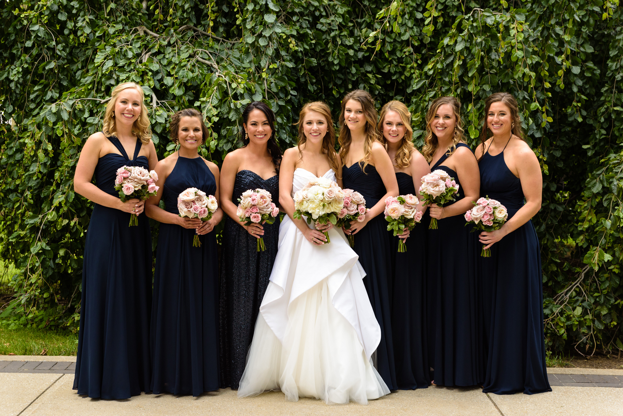 Bridesmaids in front of an exotic California inspired tree after a wedding ceremony at the Basilica of the Sacred Heart on the campus of the University of Notre Dame