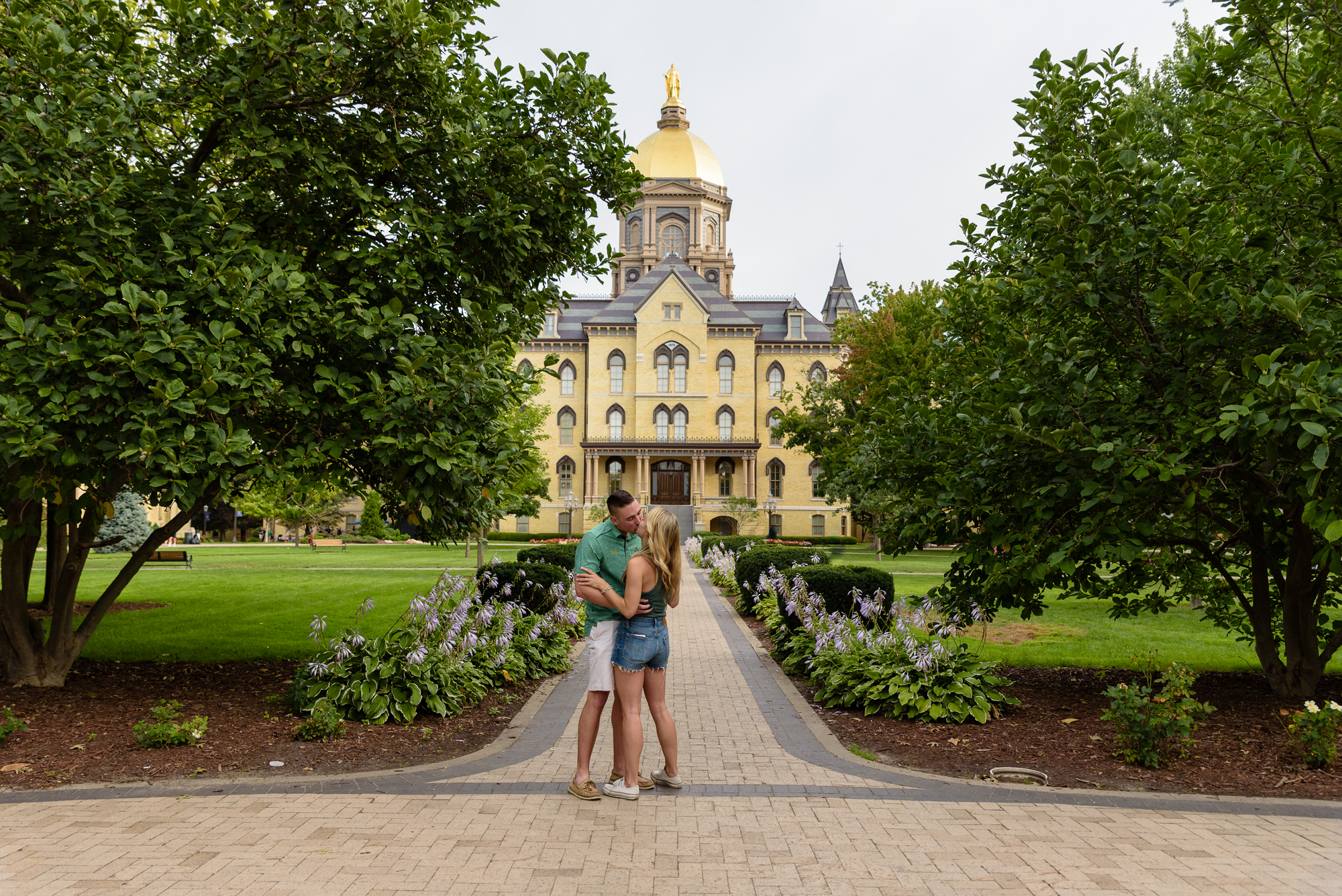 Girlfriend being proposed to in front of the Golden Dome on the campus of University of Notre Dame