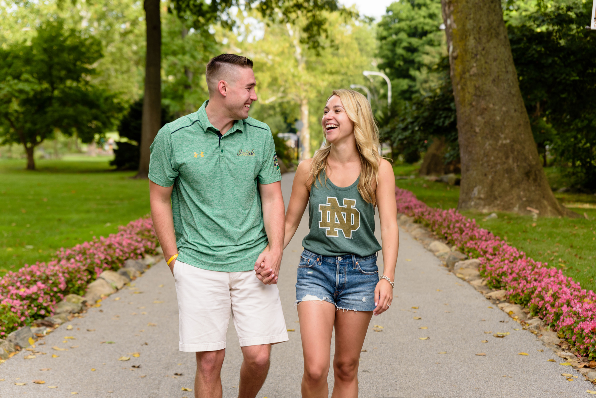 Newly engaged couple posed for photos by the lake after he proposed on the campus of University of Notre Dame