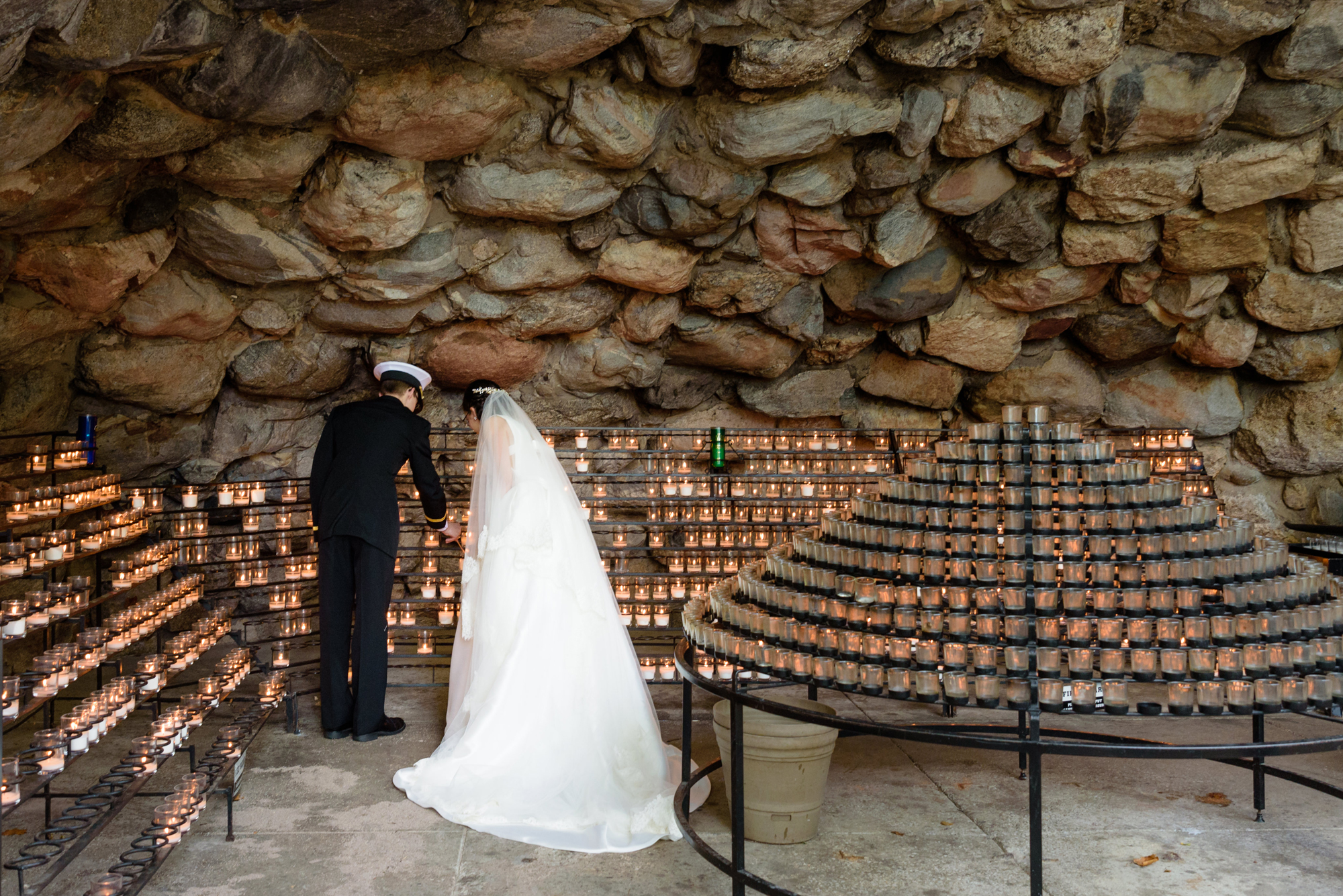 Bride & Groom Lighting a candle at the Grotto after their wedding ceremony at the Basilica of the Sacred Heart on the campus of the University of Notre Dame