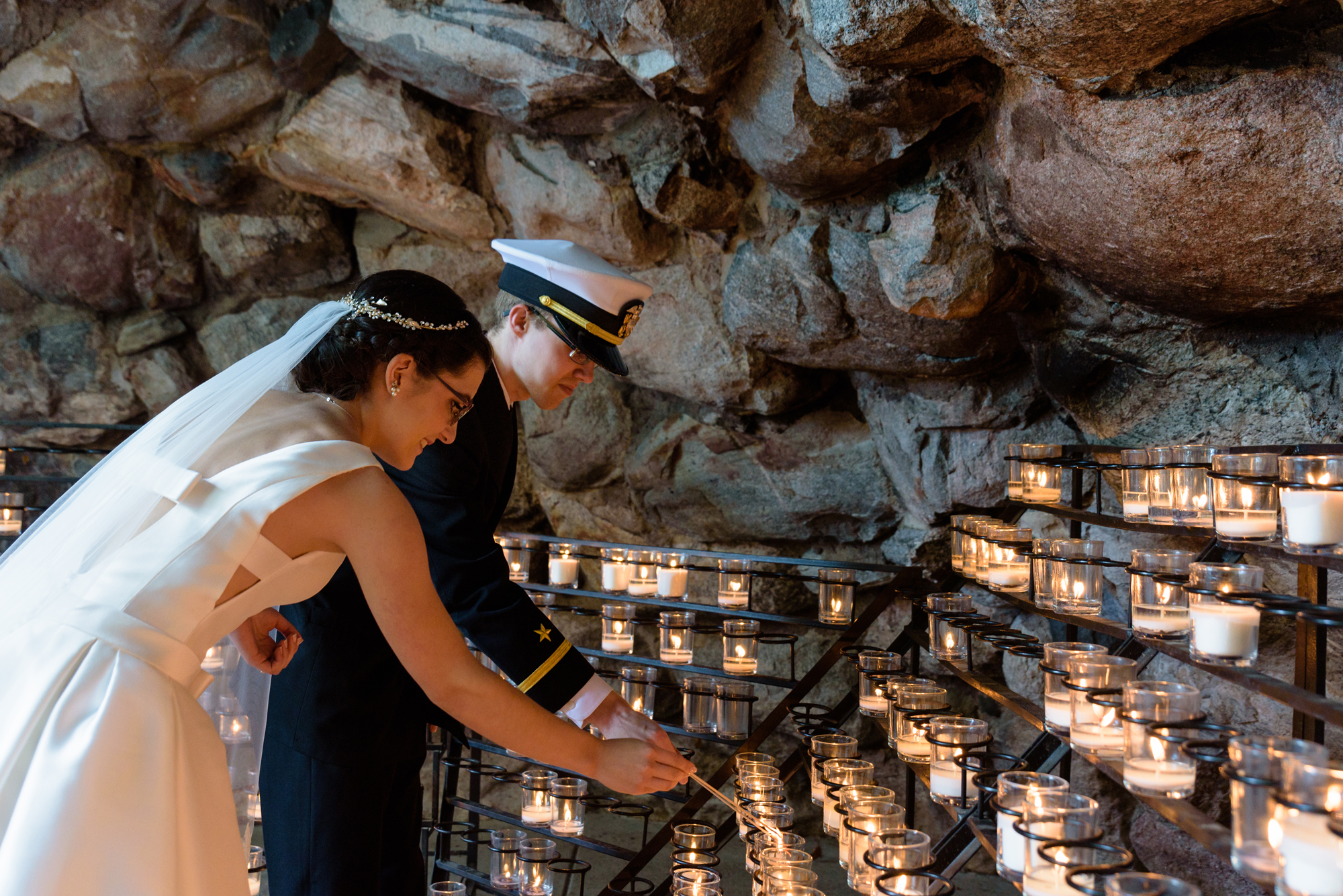 Bride & Groom Lighting a candle at the Grotto after their wedding ceremony at the Basilica of the Sacred Heart on the campus of the University of Notre Dame