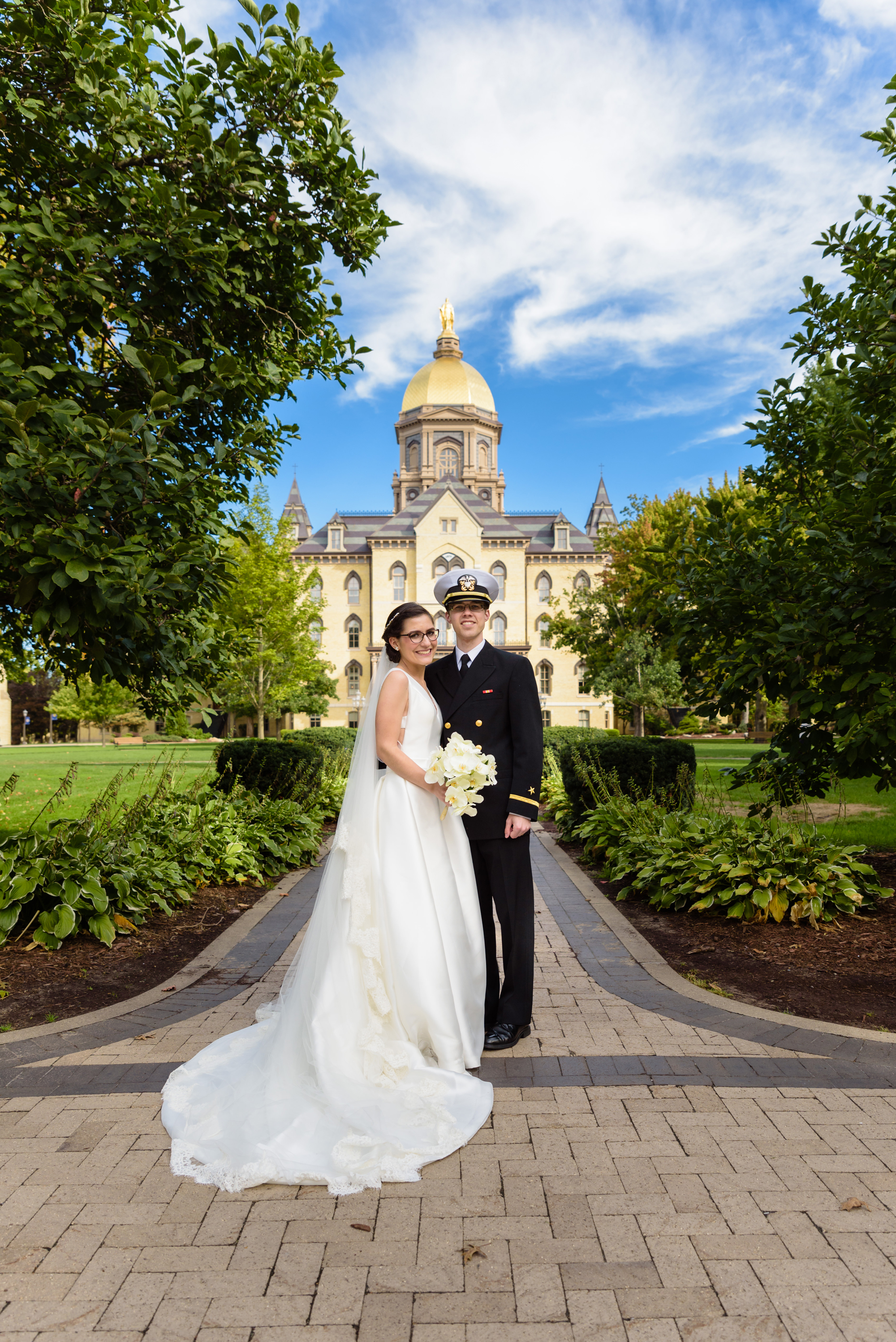 Bride & Groom in front of the Golden Dome on God Quad after their wedding ceremony at the Basilica of the Sacred Heart on the campus of the University of Notre Dame