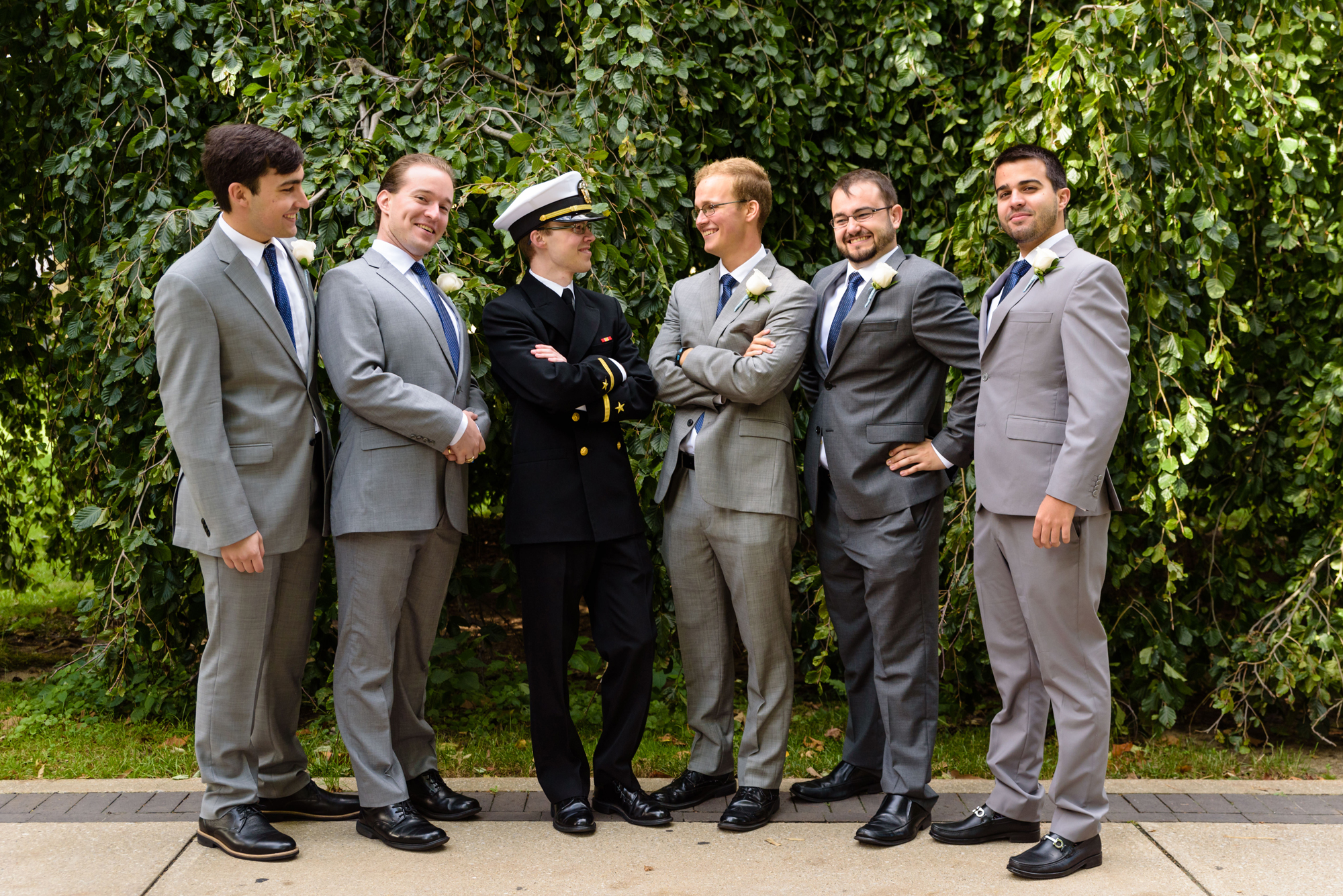 Groomsmen in front of an exotic tree on God Quad after a wedding ceremony at the Basilica of the Sacred Heart on the campus of the University of Notre Dame