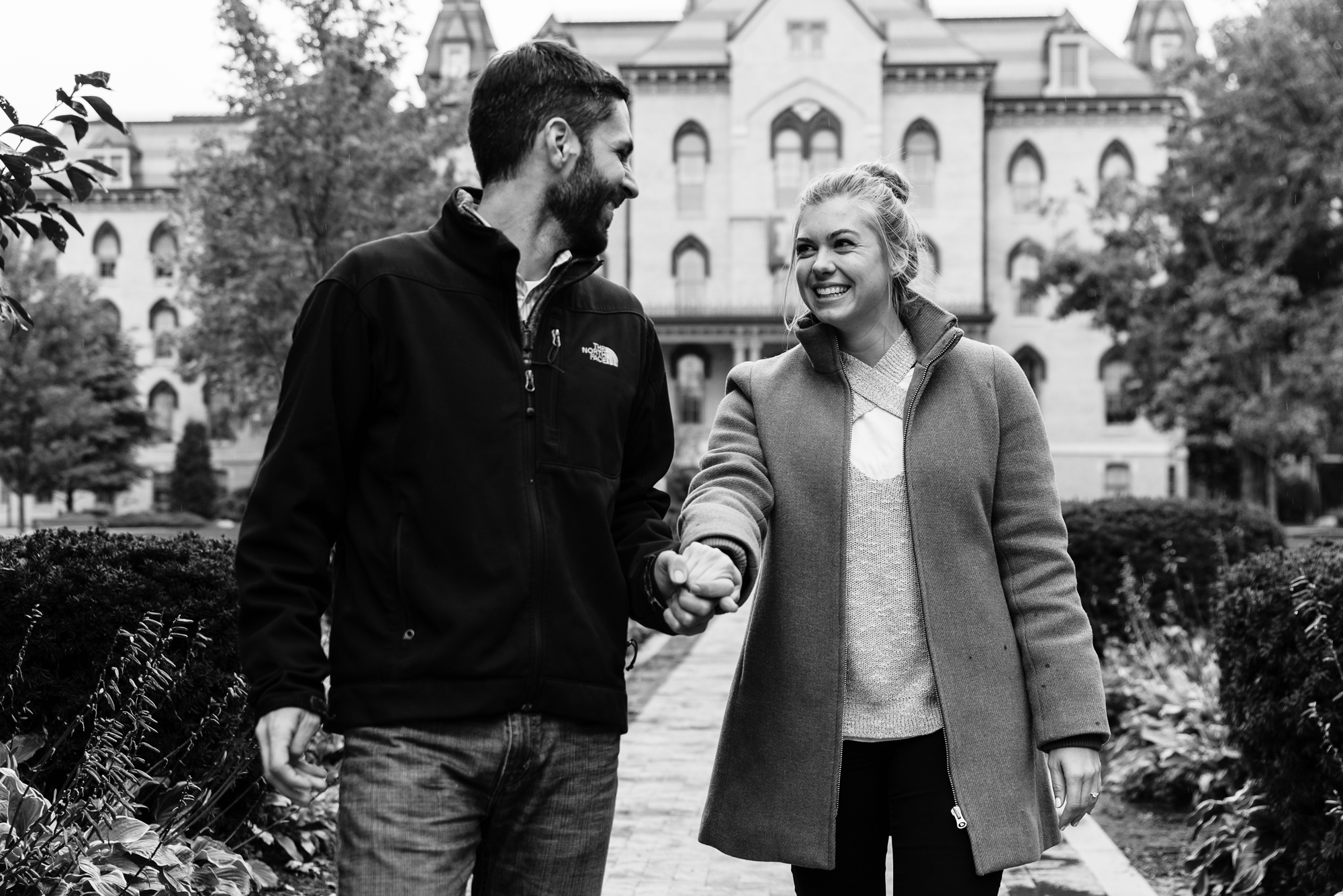 Newly engaged couple in front of the Golden Dome on the campus of the University of Notre Dame