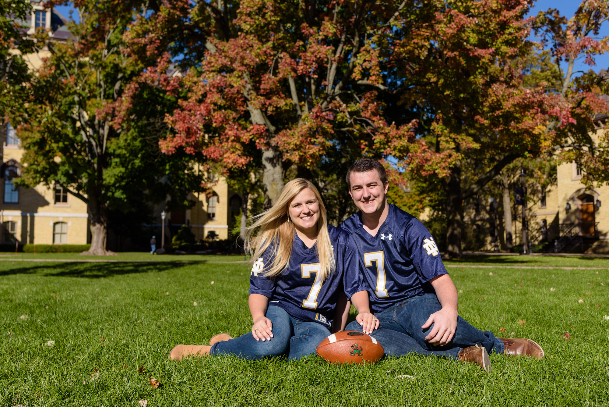 Engaged couple in front of the Golden Dome on the campus of the University of Notre Dame