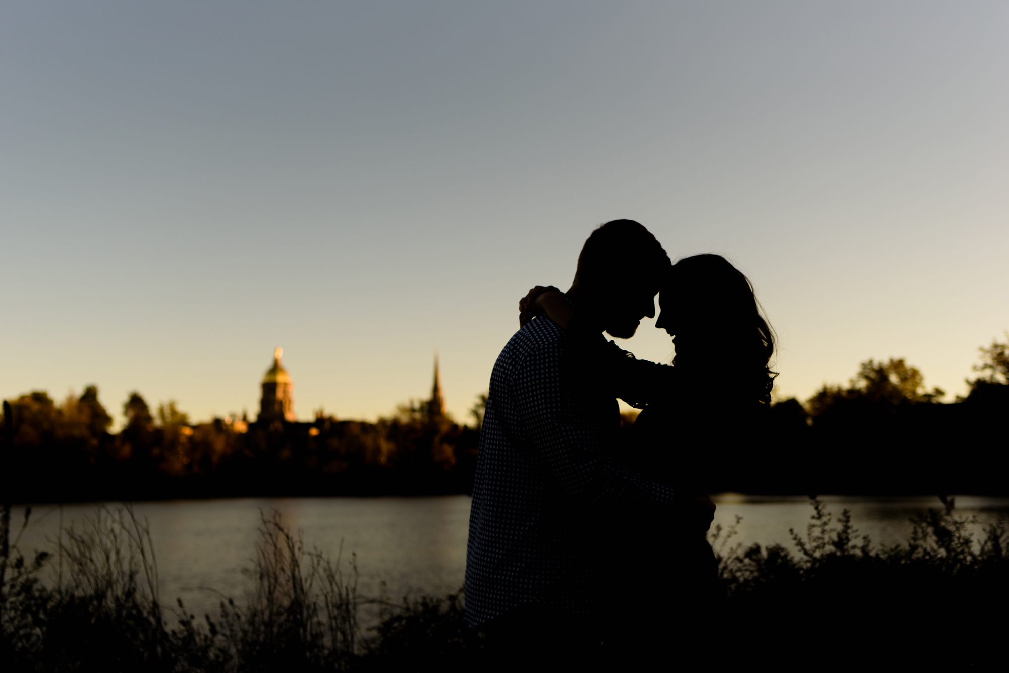 Engaged couple around St. Joseph's Lake on the campus of the University of Notre Dame