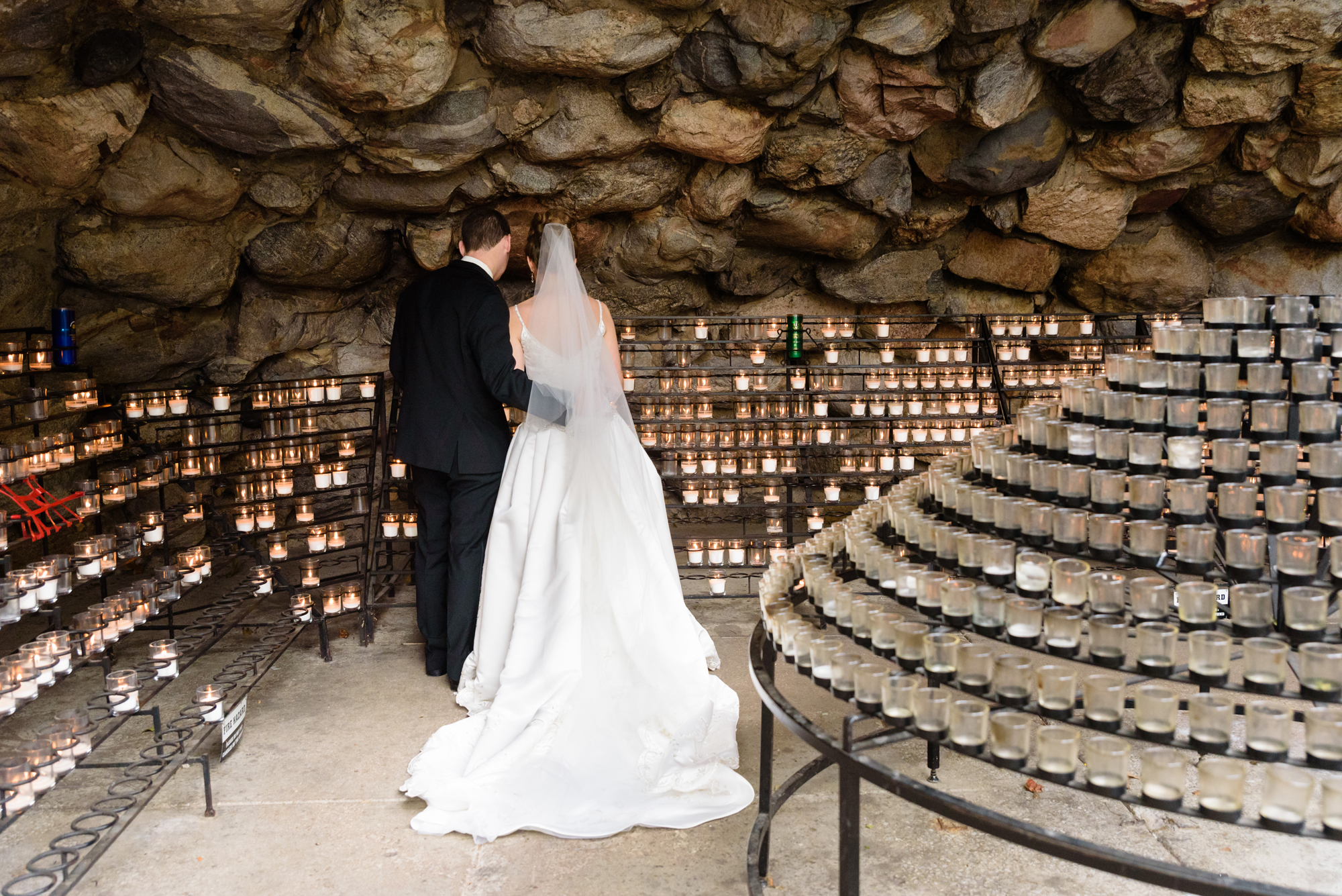 Bride & Groom lighting a candle at the Grotto after their wedding ceremony at the Basilica of the Sacred Heart on the campus of the University of Notre Dame