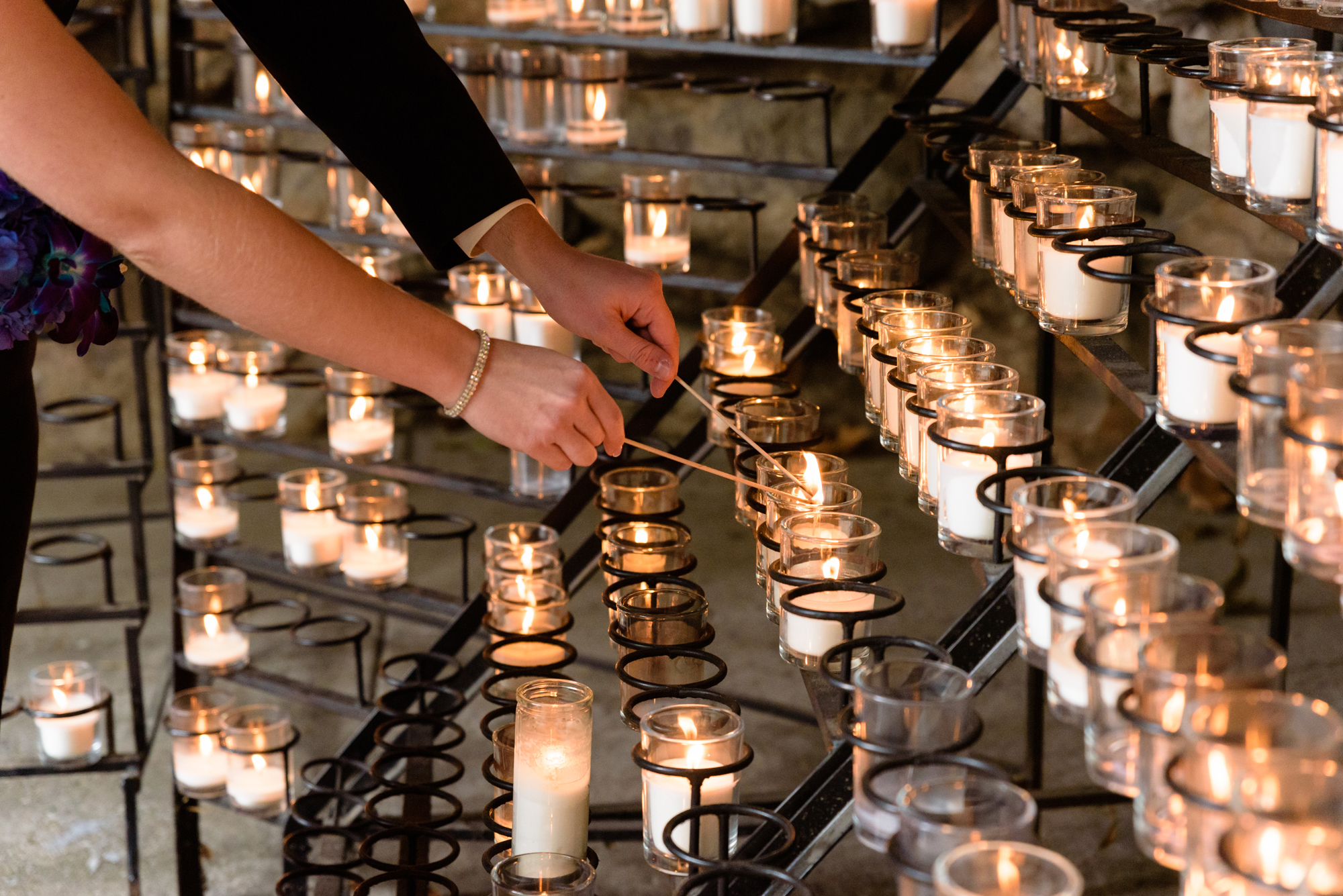 Bride & Groom lighting a candle at the Grotto after their wedding ceremony at the Basilica of the Sacred Heart on the campus of the University of Notre Dame