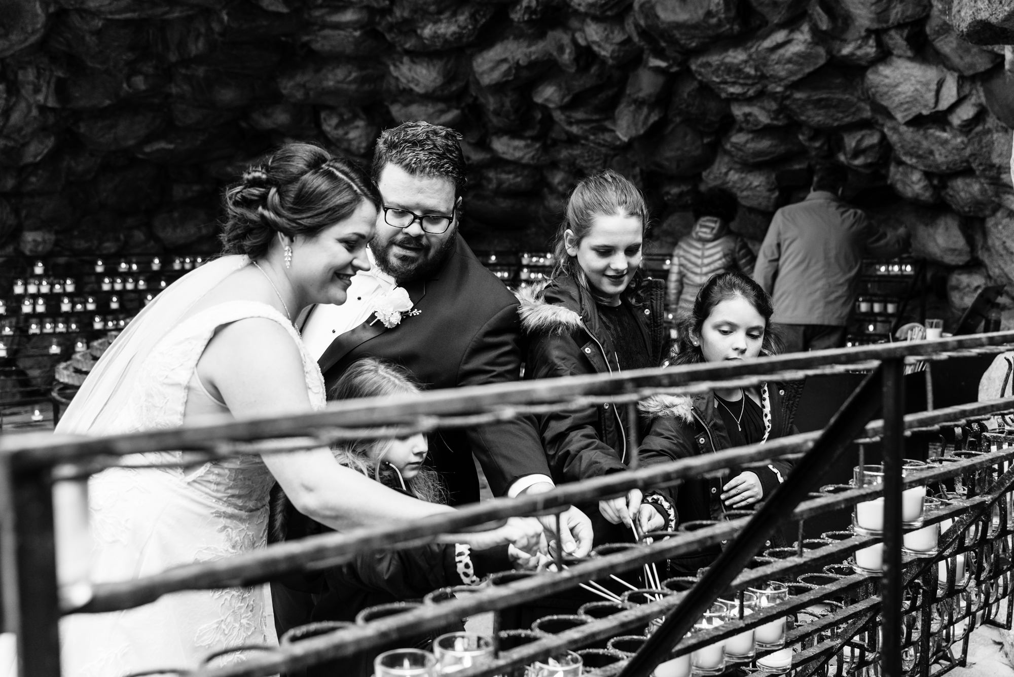 Bride & Groom lighting a candle at the Grotto after their wedding ceremony at the Basilica of the Sacred Heart on the campus of the University of Notre Dame