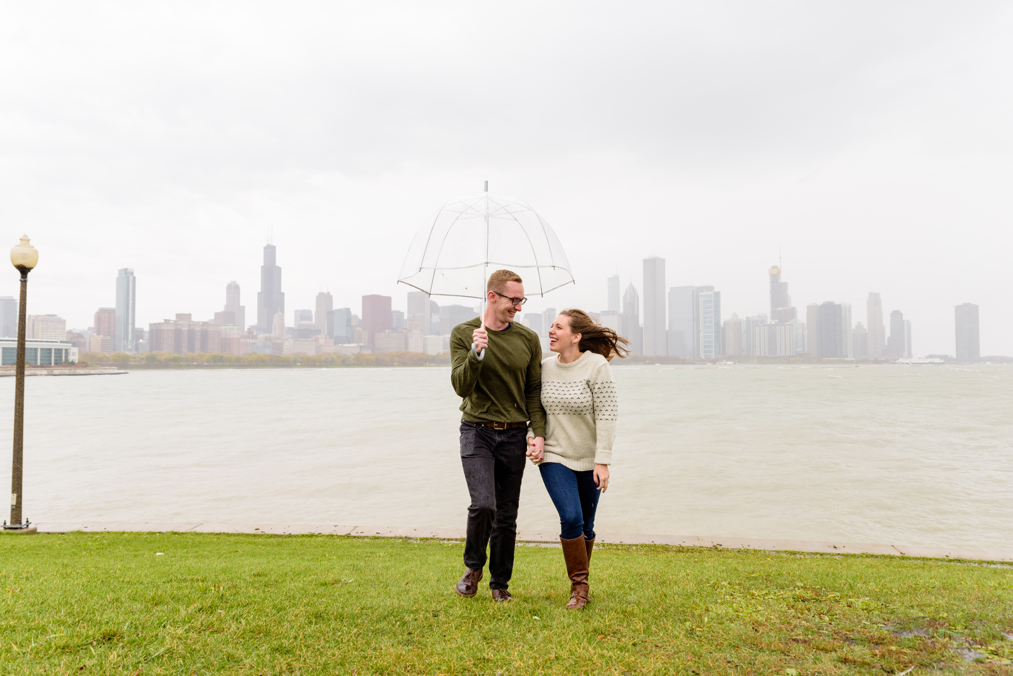 Engaged couple at the Planetarium with the Chicago skyline behind them