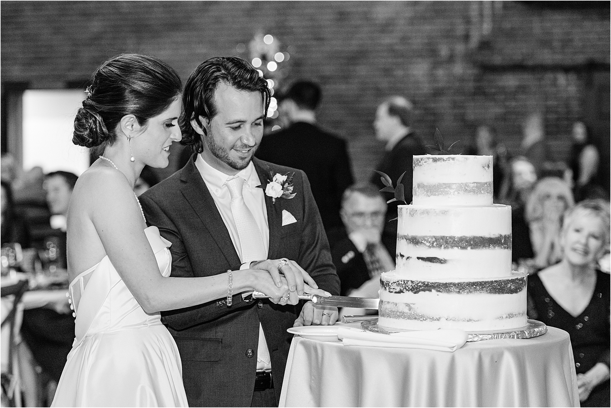 067-Caitlin-Kevin-Katie-Whitcomb-Photography-classic-elegant-the-armory-winter-wedding-cake-cutting.jpg